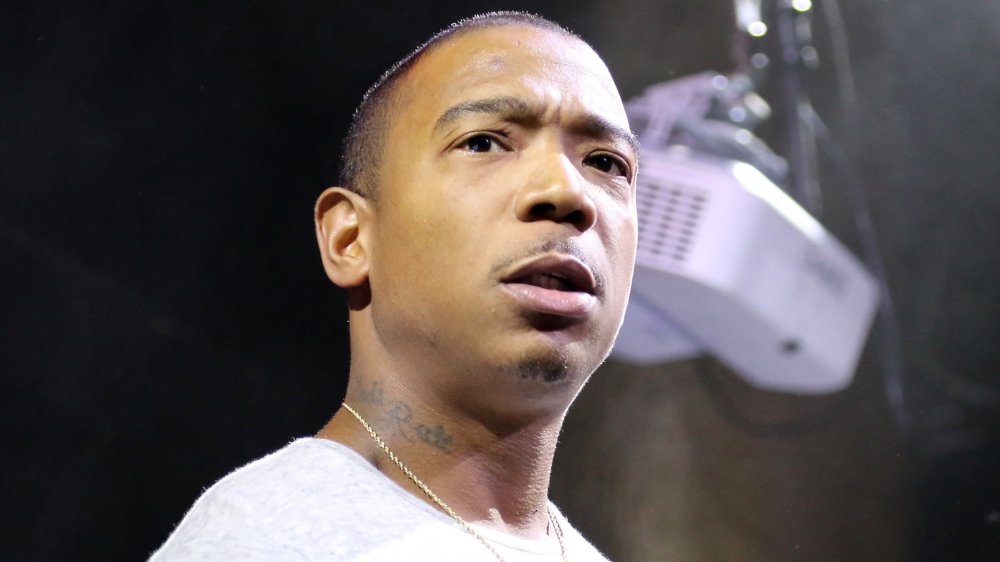 Ja Rule with a serious expression, wearing a white t-shirt during a performance