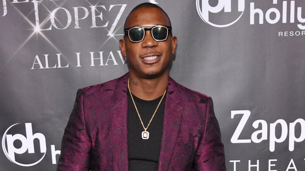 Ja Rule smiling in a purple blazer and black t-shirt and sunglasses