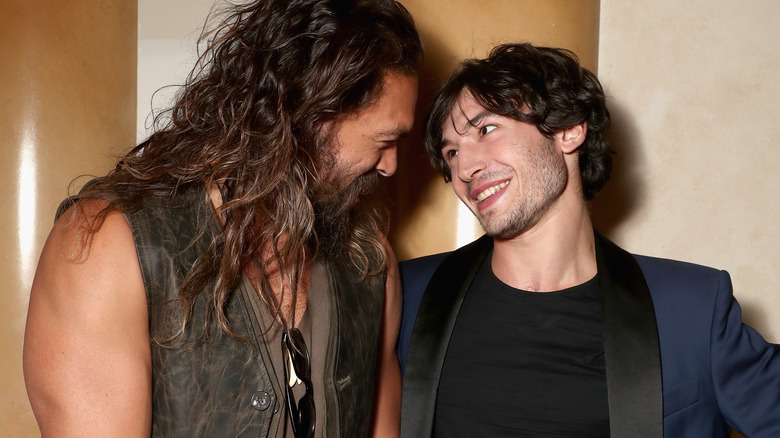 Jason Momoa and Ezra Miller look at each other