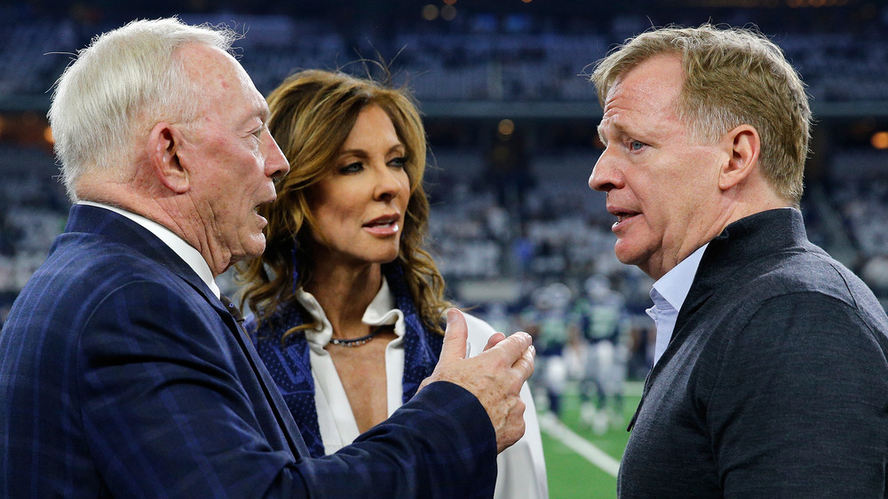 Jerry Jones, Charlotte Jones Anderson, and Roger Goodell exchanging words on the field 