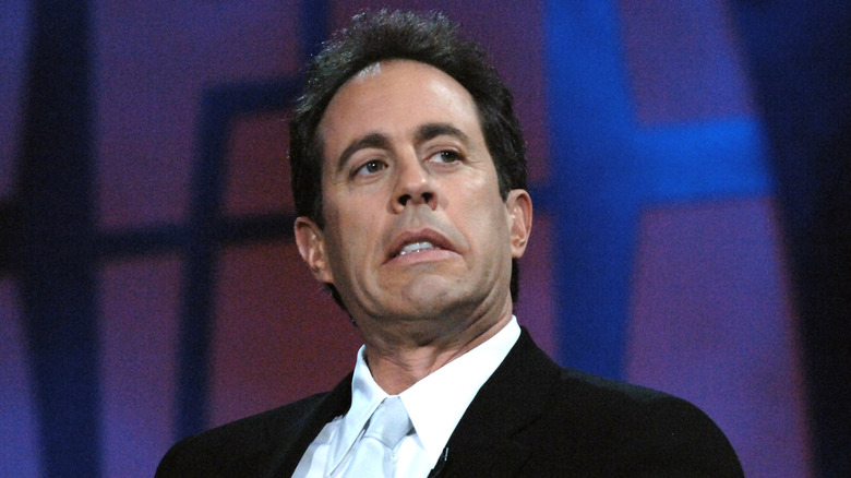 Jerry Seinfeld frowning on stage