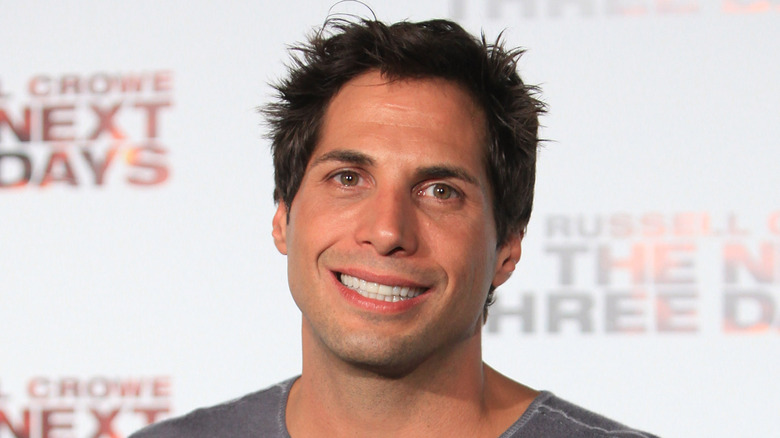 Joe Francis smiling on the red carpet