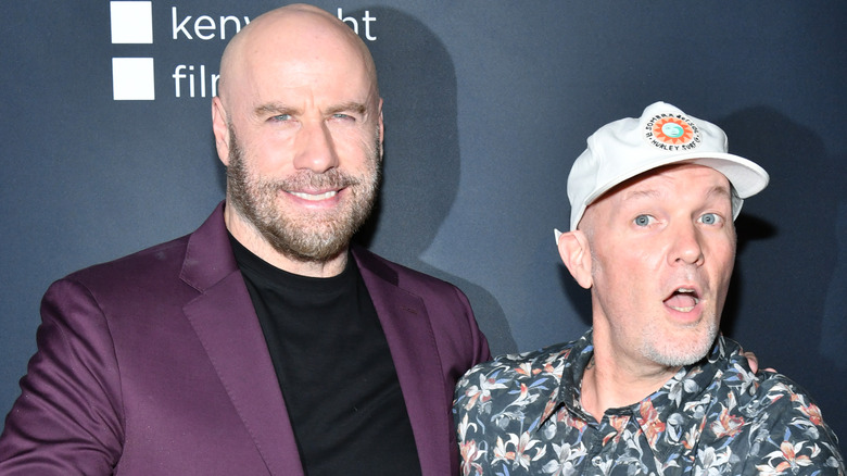 John Travolta and Fred Durst posing 