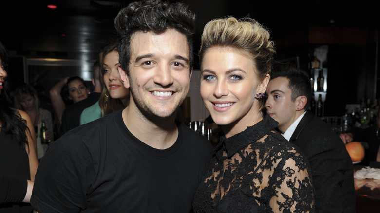 Mark Ballas wearing a black t-shirt with Julianne Hough wearing a black lace dress