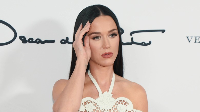 Katy Perry wearing a white lace halter gown