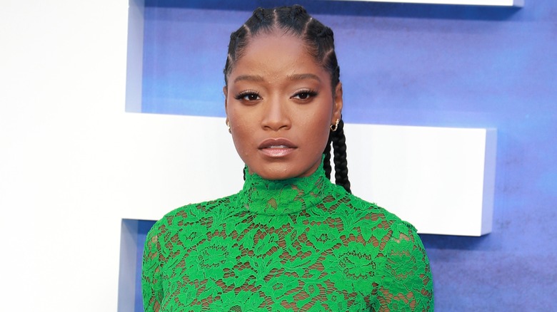 Keke Palmer stands at red carpet event