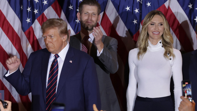 Donald, Eric, and Lara Trump stand with American flags