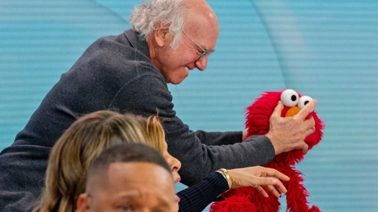 Larry David attacking Elmo puppet