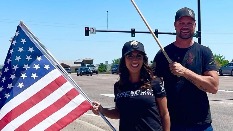 Lauren and Jayson Boebert pose with flags