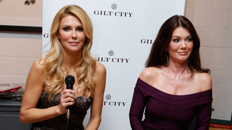 Brandi Glanville smiling next to Lisa Vanderpump making a funny face