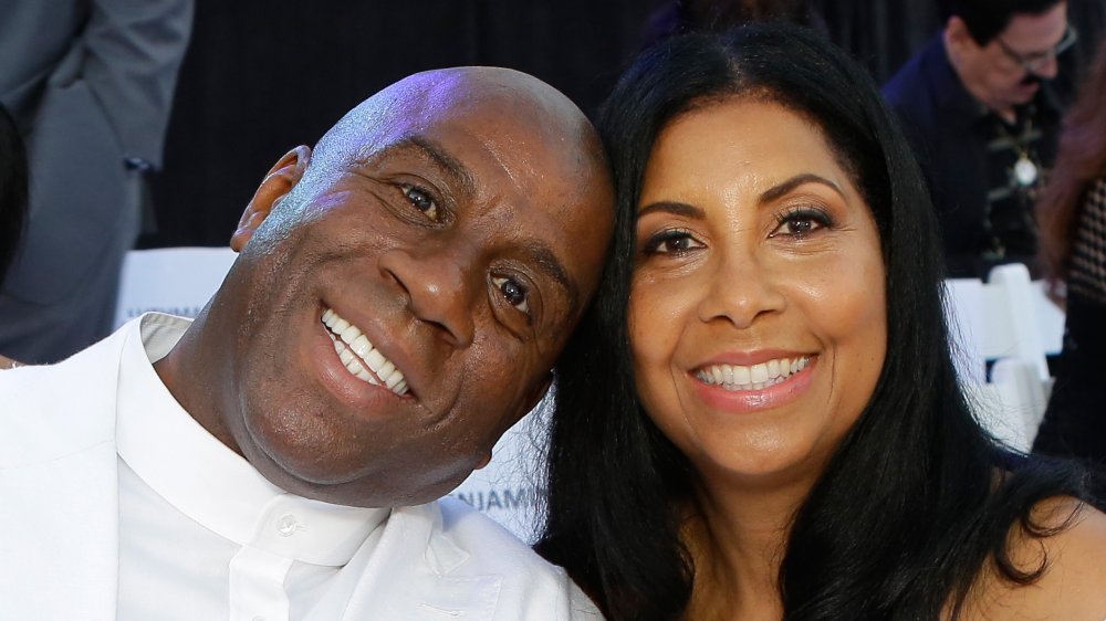 Magic Johnson with head resting on Cookie Johnson, both smiling