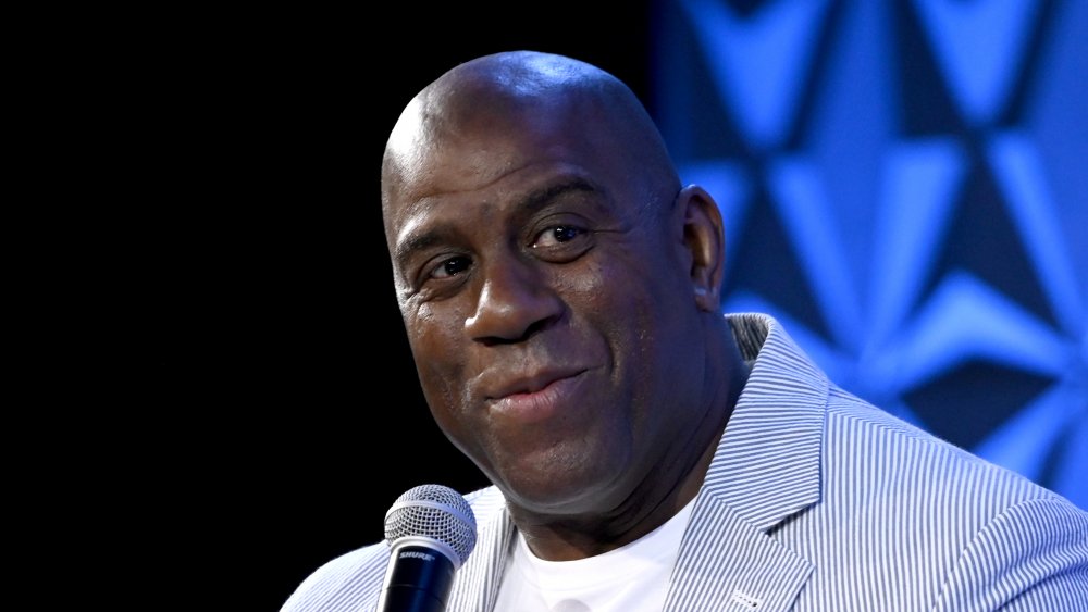 Magic Johnson with microphone, grinning