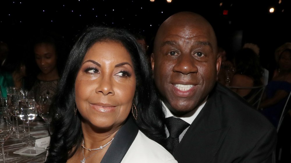 Cookie Johnson gazing off camera, Magic Johnson smiling