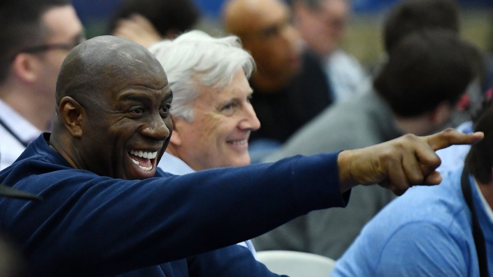 Magic Johnson pointing and laughing in a crowd