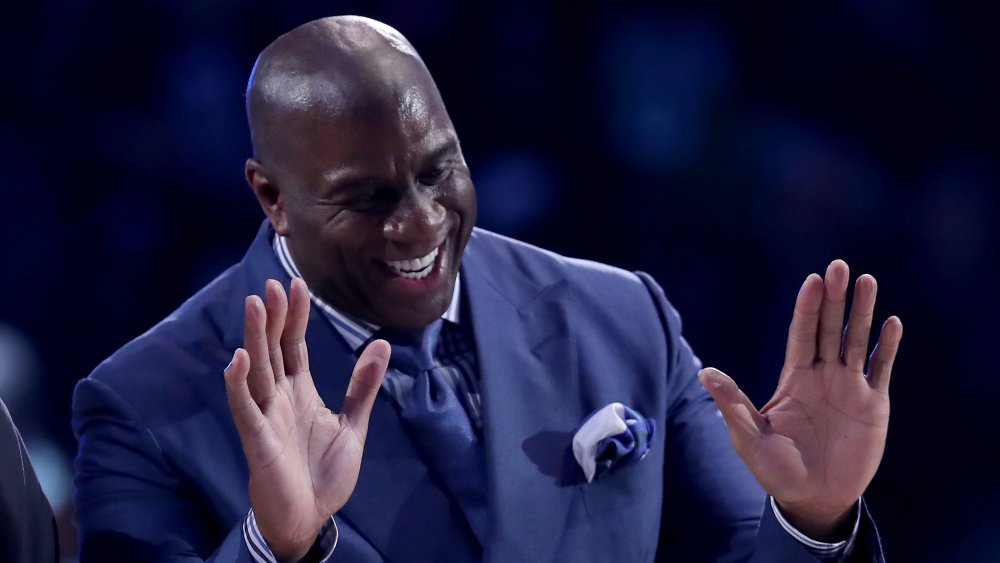 Magic Johnson with hands up, laughing