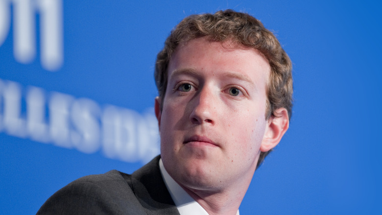  Mark Zuckerberg in grey suit curly hair