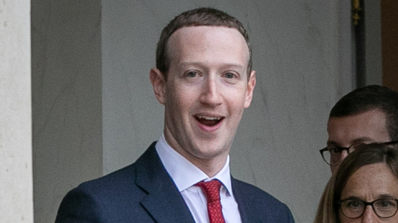 Mark Zuckerberg in red tie smiling