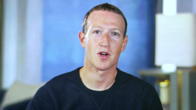 Mark Zuckerberg in blue shirt talking to camera