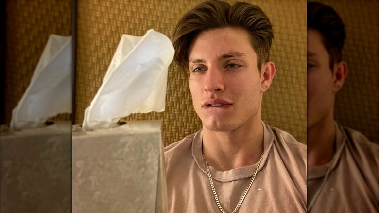 Matt Rife looking at tissue