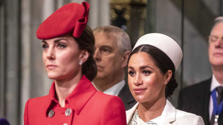 Meghan Markle and Kate Middleton standing