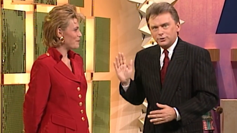 Vanna White laughing at a grinning Pat Sajak