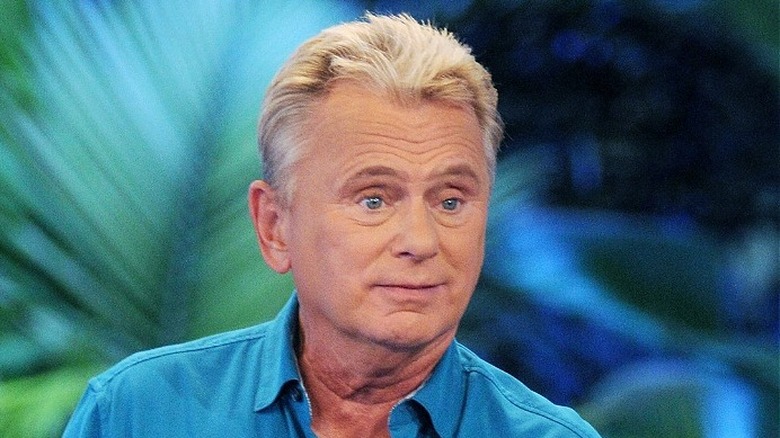 Pat Sajak looking confused in front of palm fronds