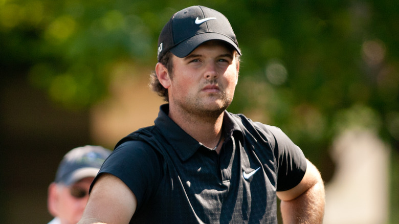 Patrick Reed, looking serious, standing