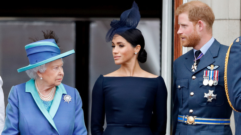 Queen Elizabeth, Meghan Markle, and Prince Harry talking