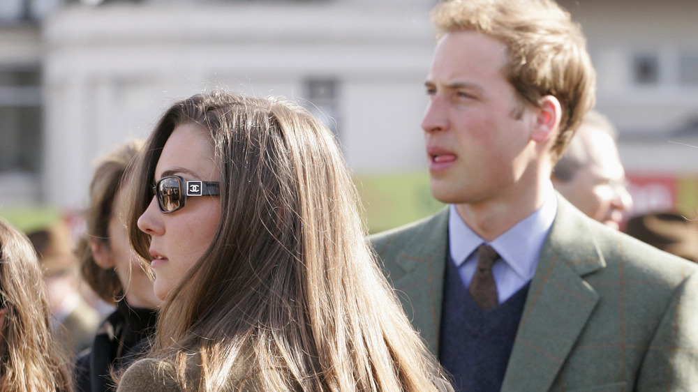 Kate Middleton and Prince William standing outside