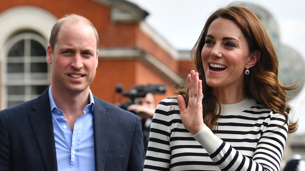 Prince William and Kate Middleton smiling and waving