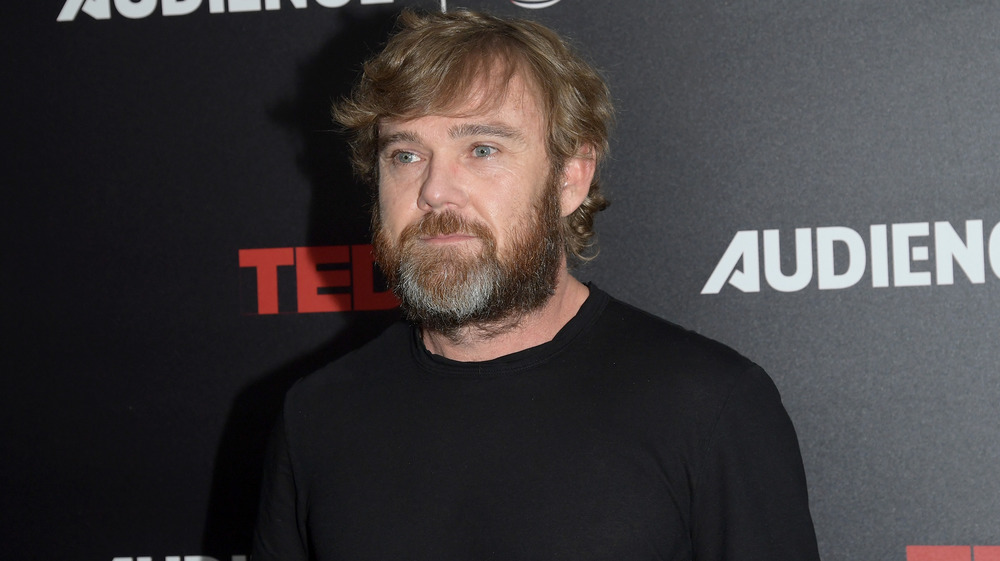 Ricky Schroder in front of TED promo wall