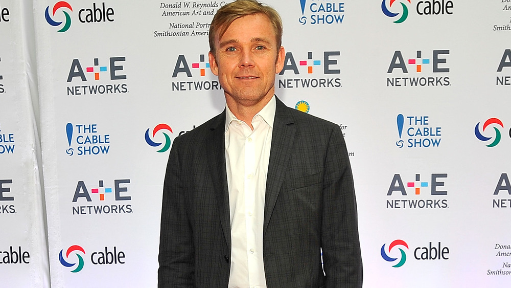 Ricky Schroder in front of promotional wall