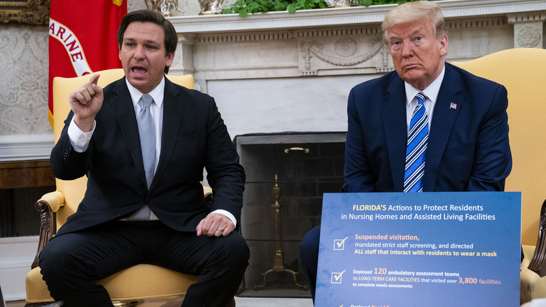 Ron DeSantis and Donald Trump sitting