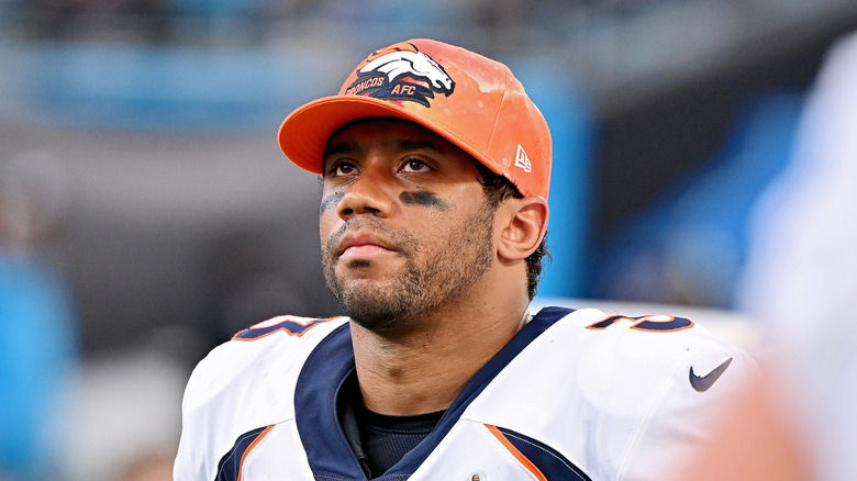 Russell Wilson wearing Denver Broncos hat