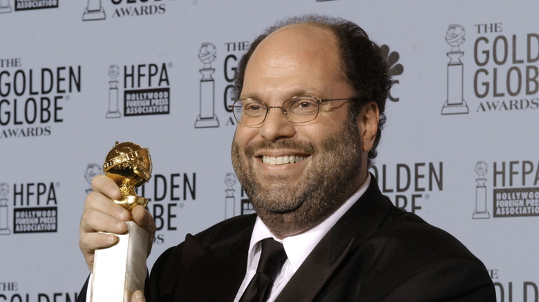 Scott Rudin holding up his Golden Globe award 