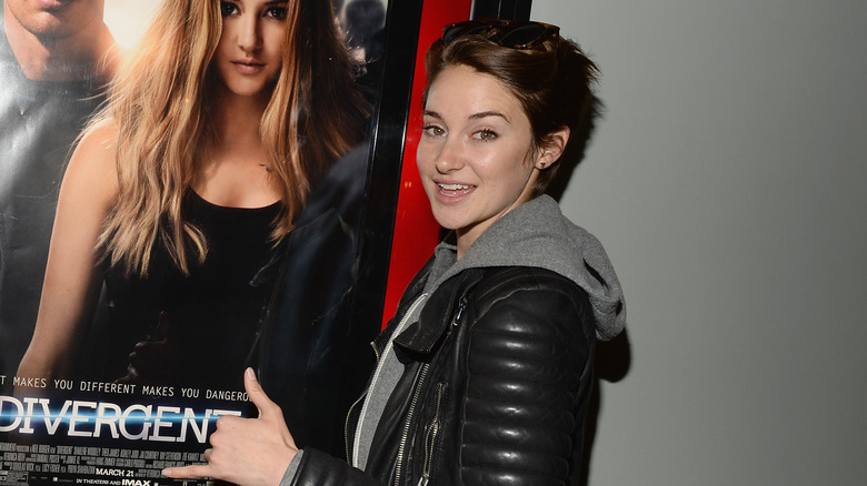 Shailene Woodley with 'Divergent' poster