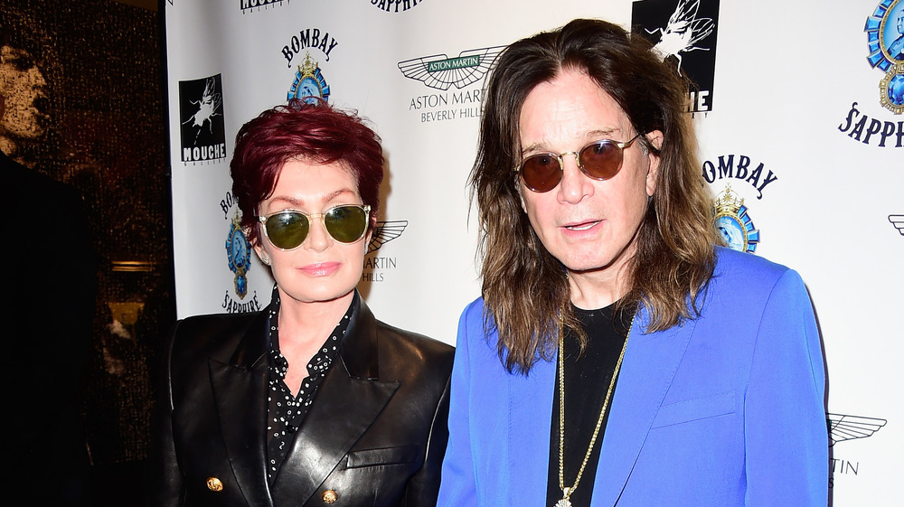 Sharon and Ozzy Osbourne wearing sunglasses on the red carpet 