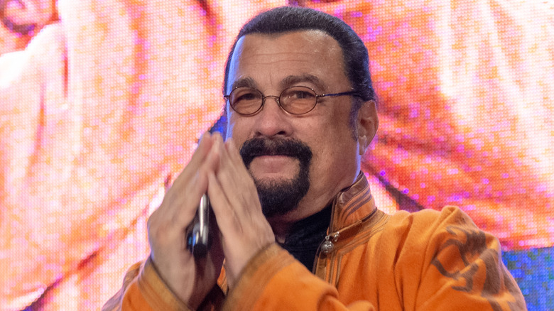 Steven Seagal praying on stage