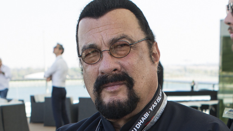 Steven Seagal with glasses and spray hairline