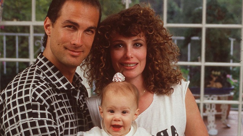 Steven Seagal and Kelly LeBrock holding baby