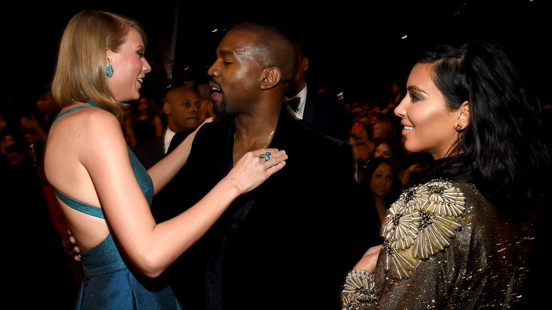 Taylor Swift hugs Kanye West as Kim Kardashian looks on