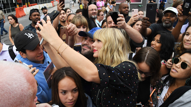 Taylor Swift taking selfie with fans