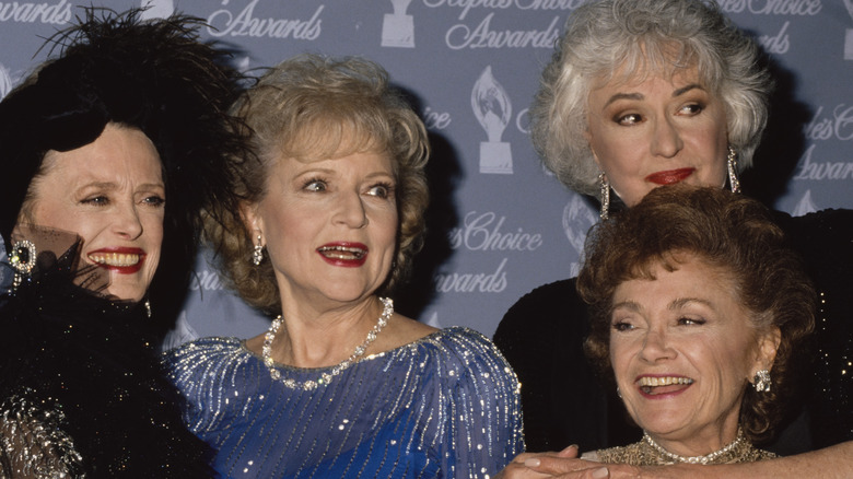 Rue McClanahan, Betty White, Bea Arthur, and Estelle Getty smiling all posing