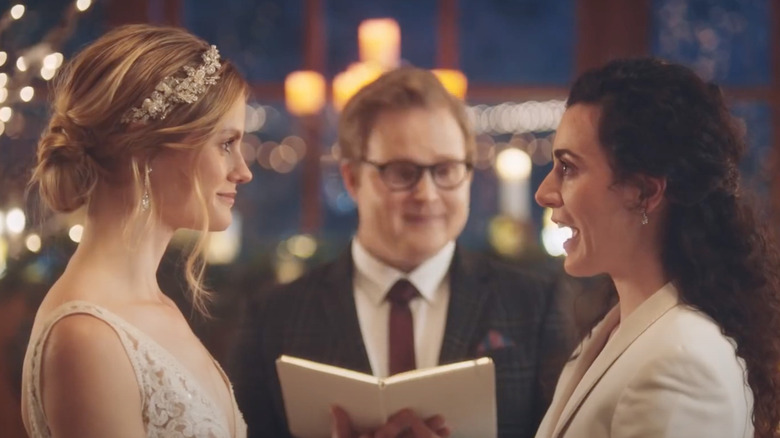 Two women stand at the altar in a Zola commercial