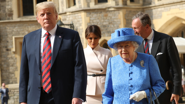 Donald Trump, Melania Trump, and Queen Elizabeth II walking