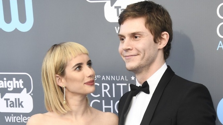 Emma Roberts looking up at Evan Peters