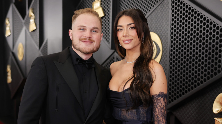 Zach Bryan and Brianna Chickenfry LaPaglia dresses in black at formal event