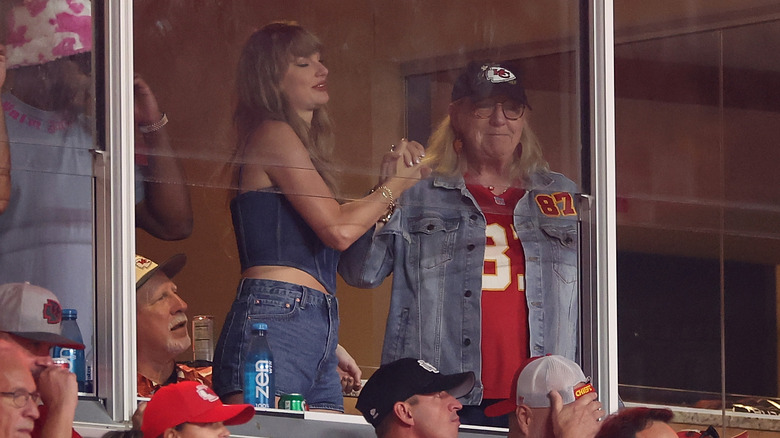 Taylor Swift holding hands with Donna Kelce