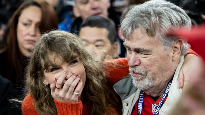 Taylor Swift laughing with Ed Kelce