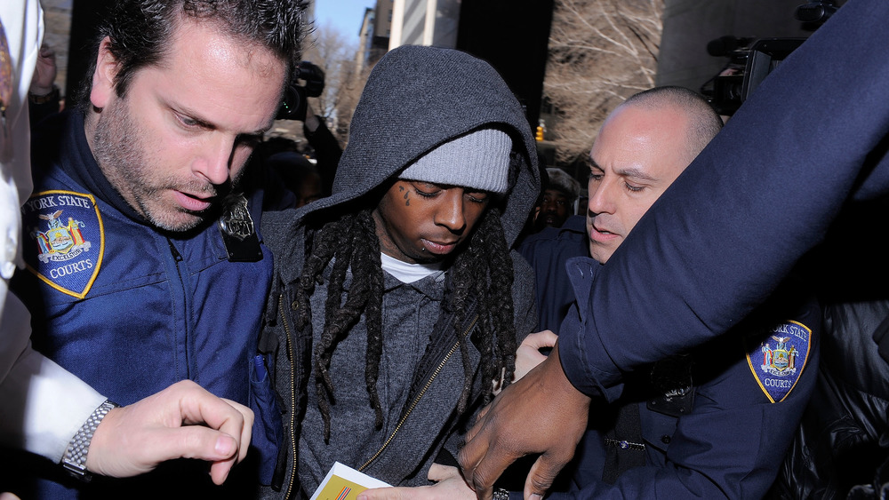 Lil Wayne escorted by police